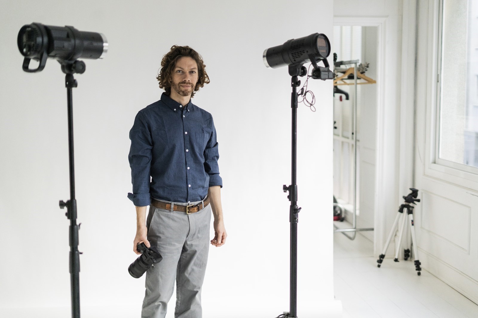 male photographer in studio with two lights