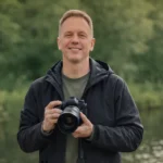 Dave king posing with a camera outside