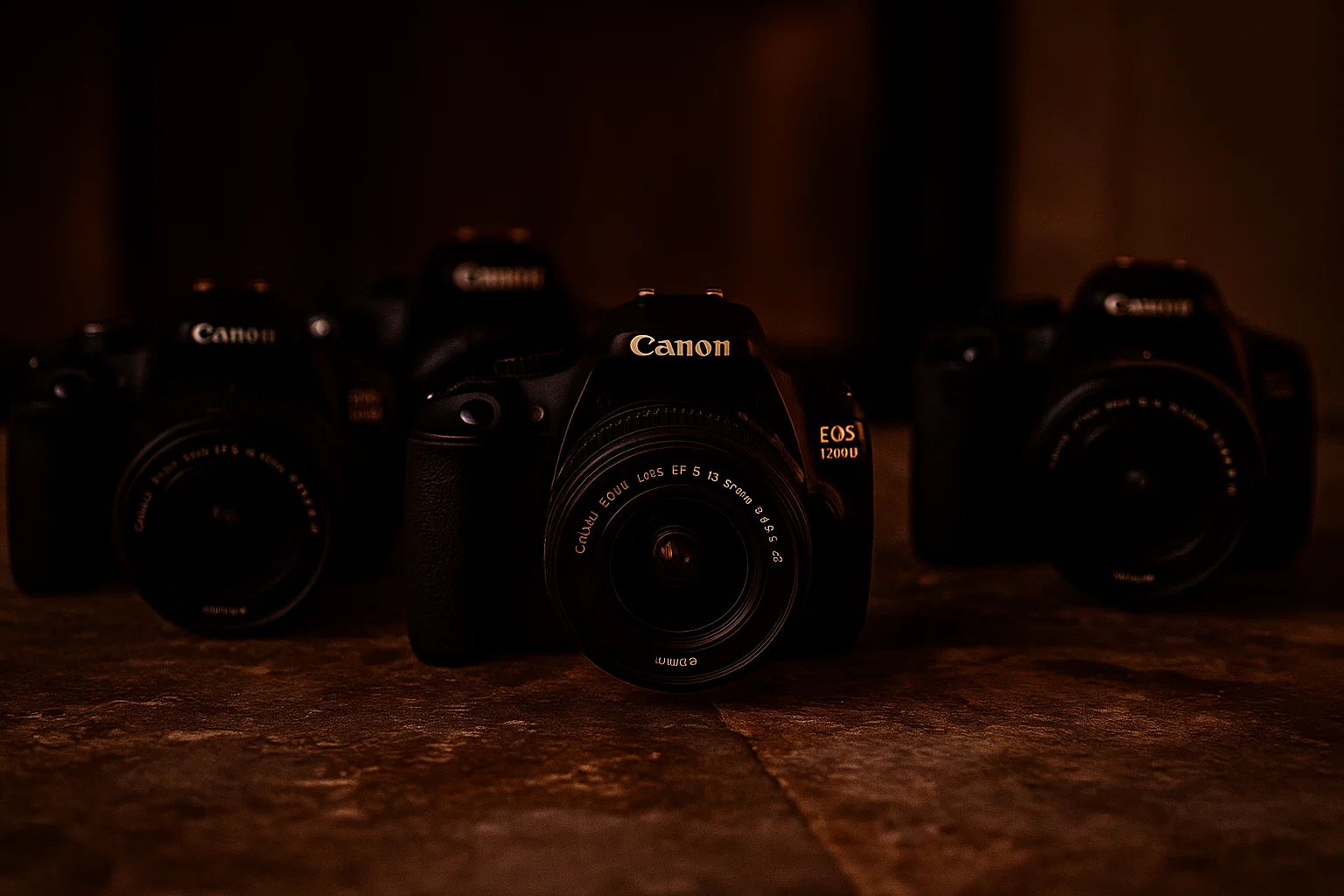 A group of canon cameras next to each other 