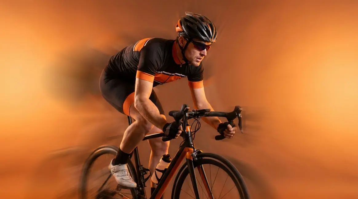 Panning photography example showing sharp cyclist against blurred streaked background conveying motion